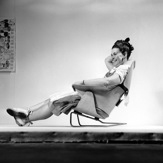 Ray Eames sitting on an experimental lounge chair, 1946 © Eames Office LLC